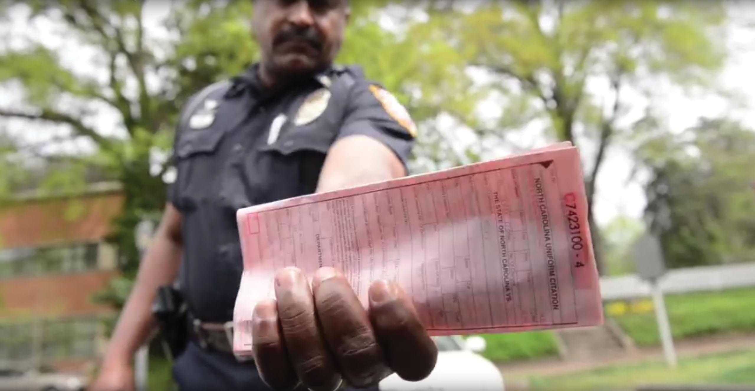 Police officer issuing a seat belt ticket
